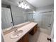 Bathroom with vanity sink, mirror, shower, and tile flooring at 27355 Breakers Dr, Wesley Chapel, FL 33544