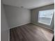 Bright bedroom with wood floors and a window at 27355 Breakers Dr, Wesley Chapel, FL 33544