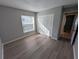 Bedroom with wood-look floors, a window, and closet at 27355 Breakers Dr, Wesley Chapel, FL 33544