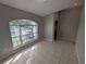 Tiled entryway with decorative glass door and large arched window at 27355 Breakers Dr, Wesley Chapel, FL 33544