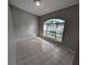 Entryway with tiled flooring, an arched window, and a front door with decorative glass at 27355 Breakers Dr, Wesley Chapel, FL 33544