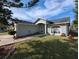 Light blue single-story home with a landscaped front yard and a welcoming walkway at 27355 Breakers Dr, Wesley Chapel, FL 33544