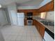Kitchen featuring wood cabinetry, stainless steel appliances, and tiled flooring at 27355 Breakers Dr, Wesley Chapel, FL 33544