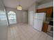 Eat-in kitchen area with tile flooring, arched window, and a view of the kitchen at 27355 Breakers Dr, Wesley Chapel, FL 33544