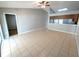 Living room with tile flooring, ceiling fan, and access to another room at 27355 Breakers Dr, Wesley Chapel, FL 33544