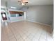 Open living room with tile floors, ceiling fan, and view of adjacent spaces at 27355 Breakers Dr, Wesley Chapel, FL 33544