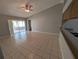 Living room with tiled flooring, ceiling fan, and sliding glass doors at 27355 Breakers Dr, Wesley Chapel, FL 33544