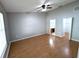 Main bedroom with wood-look flooring, ceiling fan, and access to a bathroom and closet at 27355 Breakers Dr, Wesley Chapel, FL 33544