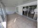 Sunroom with tile flooring and sliding glass door to the backyard at 27355 Breakers Dr, Wesley Chapel, FL 33544