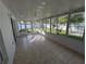 Sunroom with tiled floor, windows, and backyard access at 27355 Breakers Dr, Wesley Chapel, FL 33544