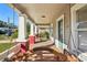 Covered front porch with a wooden swing and a view of the street at 307 W Frierson Ave, Tampa, FL 33603