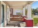 View of the front porch swing and red brick columns at 307 W Frierson Ave, Tampa, FL 33603