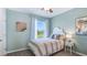 A serene and calming bedroom in light teal, with unique artwork at 3313 Ivy Hollow Dr, Plant City, FL 33565