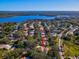 Aerial view highlighting the home's proximity to a lake, golf course, and surrounding community at 3500 Woodridge Pl, Palm Harbor, FL 34684