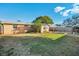 Backyard view of a single-story home with a grassy lawn at 3511 Cambridge St, New Port Richey, FL 34652