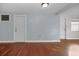 Empty living room with hardwood floors and multiple doors at 3511 Cambridge St, New Port Richey, FL 34652