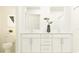 Modern bathroom featuring dual vanities and white cabinetry at 35154 Gravelly Dr, Zephyrhills, FL 33541