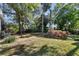 Spacious backyard with grassy areas, trees, and a chain-link fence at 3602 W Dale Ave, Tampa, FL 33609