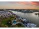 Sunset aerial view of a waterfront community with pool, docks, and boats at 370 Pinellas Bayway S # E, Tierra Verde, FL 33715