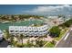 Aerial view of the waterfront community with palm trees, docks, and nearby buildings at 370 Pinellas Bayway S # E, Tierra Verde, FL 33715