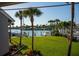 Lush tropical backyard with a view of the marina and boats at 370 Pinellas Bayway S # E, Tierra Verde, FL 33715