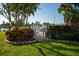 Gated backyard with tropical landscaping and pool access at 370 Pinellas Bayway S # E, Tierra Verde, FL 33715