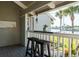 Relaxing balcony with water views, bar seating, and tropical landscaping at 370 Pinellas Bayway S # E, Tierra Verde, FL 33715