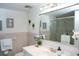 Bathroom with white vanity, large mirror, and glass shower enclosure at 370 Pinellas Bayway S # E, Tierra Verde, FL 33715