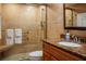 Modern bathroom with marble countertops, glass shower, and accessibility features at 370 Pinellas Bayway S # E, Tierra Verde, FL 33715