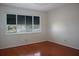 Empty bedroom with hardwood floors and a large window at 370 Pinellas Bayway S # E, Tierra Verde, FL 33715
