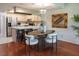 Kitchen and dining area combination with modern furniture, a breakfast bar, and hardwood floors at 370 Pinellas Bayway S # E, Tierra Verde, FL 33715