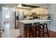 Modern kitchen with white countertops, stainless steel appliances, breakfast bar, and ample cabinetry at 370 Pinellas Bayway S # E, Tierra Verde, FL 33715