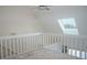 Loft area with a skylight and overlooking the living room below at 370 Pinellas Bayway S # E, Tierra Verde, FL 33715