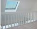 Loft area with skylight, white railing, and carpeted floor at 370 Pinellas Bayway S # E, Tierra Verde, FL 33715