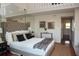 Main bedroom with high ceilings, hardwood floors, and a tufted headboard at 370 Pinellas Bayway S # E, Tierra Verde, FL 33715