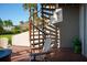 Spiral staircase to patio with seating and marina views at 370 Pinellas Bayway S # E, Tierra Verde, FL 33715