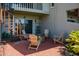 Cozy patio with fire pit and seating area, surrounded by tropical plants at 370 Pinellas Bayway S # E, Tierra Verde, FL 33715