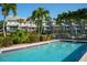 Community pool with lush landscaping and ample seating at 370 Pinellas Bayway S # E, Tierra Verde, FL 33715
