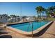 Community pool with views of the marina and lush landscaping at 370 Pinellas Bayway S # E, Tierra Verde, FL 33715