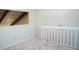 View of a carpeted staircase with white railing and wood-beamed ceiling detail at 370 Pinellas Bayway S # E, Tierra Verde, FL 33715