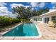 Large kidney shaped pool with patio and lounge chairs at 3700 27Th N Ave, St Petersburg, FL 33713