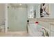 Modern bathroom with a glass-enclosed shower, soaking tub, and tiled walls at 4603 Overlook Ne Dr, St Petersburg, FL 33703
