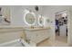 Elegant bathroom featuring dual vanities, a soaking tub, and a walk-in shower at 4603 Overlook Ne Dr, St Petersburg, FL 33703