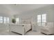 Bright bedroom with white wood furniture, plantation shutters, and a comfortable sitting area at 4603 Overlook Ne Dr, St Petersburg, FL 33703