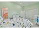 bedroom with dinosaur-themed bedding, white furniture, and an ensuite bathroom at 4603 Overlook Ne Dr, St Petersburg, FL 33703