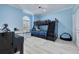 Blue bedroom with a bunk bed, desk, and large window at 4603 Overlook Ne Dr, St Petersburg, FL 33703