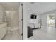 Bedroom with attached bathroom, a bed, and sliding glass doors leading to the patio at 4603 Overlook Ne Dr, St Petersburg, FL 33703