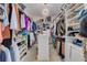 Large walk-in closet with built-in shelving, ample storage, and stylish lighting at 4603 Overlook Ne Dr, St Petersburg, FL 33703
