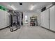 Two-car garage with storage cabinets and home gym equipment at 4603 Overlook Ne Dr, St Petersburg, FL 33703