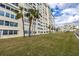Building exterior showcasing landscaping and palm trees at 4775 Cove Cir # 904, St Petersburg, FL 33708